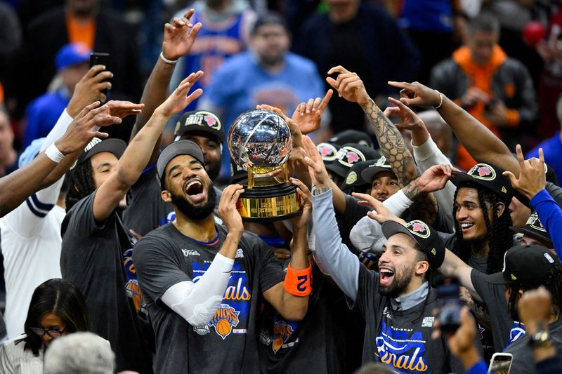 FILE PHOTO: May 25, 2026; Cleveland, Ohio, USA; New York Knicks center Karl-Anthony Towns (32) lifts the 2026 Eastern Conference trophy with teammates after defeating the Cleveland Cavaliers in game four of the eastern conference finals for the 2026 NBA playoffs at Rocket Arena. Mandatory Credit: David Richard-Imagn Images/File Photo