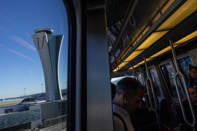 The air traffic control tower stands at the San Francisco International Airport in San Francisco, California, U.S., October 29, 2025. REUTERS/Carlos Barria/File Photo