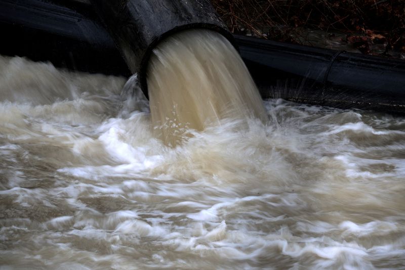 FILE PHOTO: Temporary pipes divert sewage into the C&O Canal in order to repair the Potomac Interceptor, a six-foot-wide wastewater pipe, in Cabin John, Maryland, U.S., February 18, 2026.  REUTERS/Evelyn Hockstein/File Photo