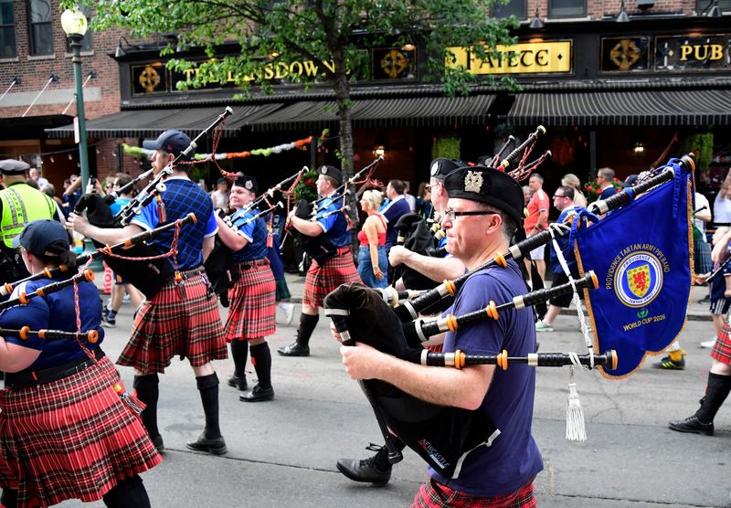 Soccer Football - FIFA World Cup 2026 - Scotland's Tartan Army march to Boston's Fenway Park baseball stadium - Boston, Massachusetts, U.S. - June 14, 2026 Scotland fans wearing kilts and playing the bagpipes during the march to Fenway Park IMAGN IMAGES via Reuters/Bob Dechiara