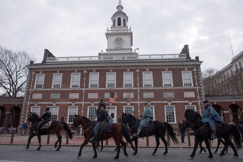 FILE PHOTO: A group of horseback riders dressed as Union soldiers pass in front of Independence Hall in Philadelphia, February 12, 2015.  REUTERS/Charles Mostoller/File Photo