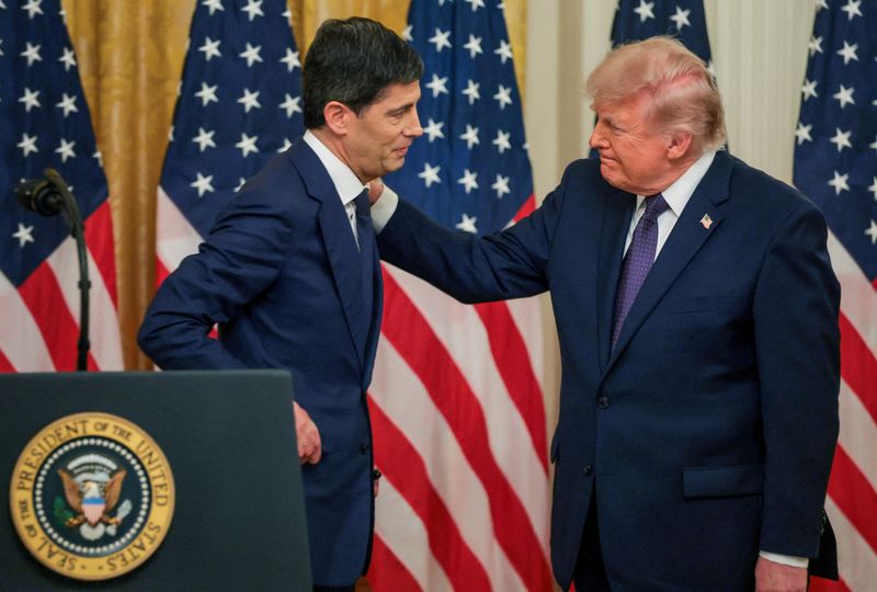 U.S. President Donald Trump greets the new Federal Reserve Chair Kevin Warsh after he was sworn in by U.S. Supreme Court Justice Clarence Thomas, in the East Room at the White House in Washington, D.C., U.S., May 22, 2026. REUTERS/Jonathan Ernst