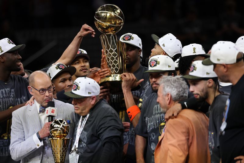 Jun 13, 2026; San Antonio, Texas, USA; New York Knicks players celebrate with the Larry O'Brien championship trophy during the trophy ceremony after game five of the 2026 NBA Finals against the San Antonio Spurs at Frost Bank Center. Mandatory Credit: Geoff Burke-Imagn Images