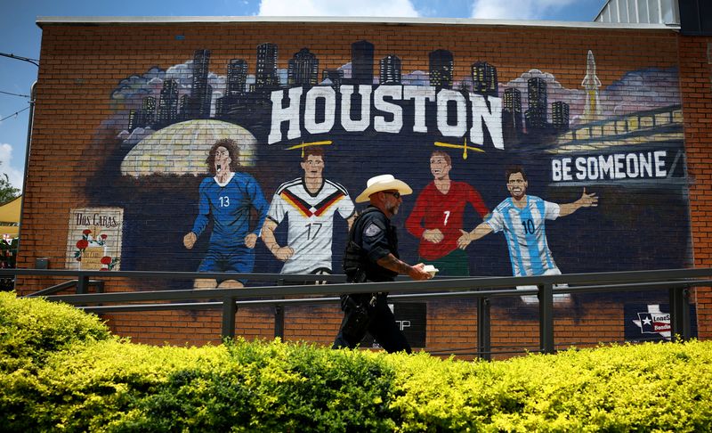 A member of the Sheriff department walks past a World Cup-themed mural in Houston, Texas, U.S. June 18, 2026. REUTERS/Phil Noble