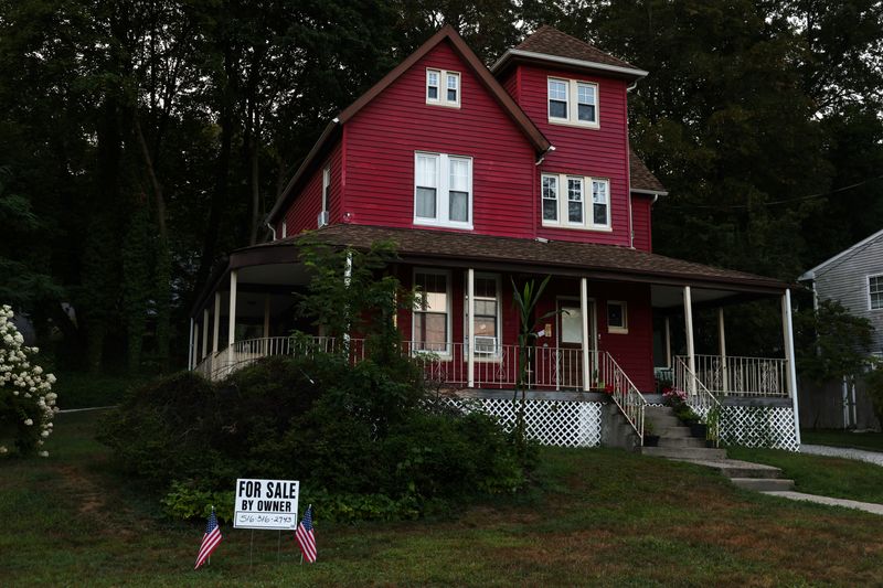 A "For Sale" sign stands in front of a house, on the North Shore of Long Island city of Glen Cove, New York, U.S., August 12, 2025. REUTERS/Shannon Stapleton