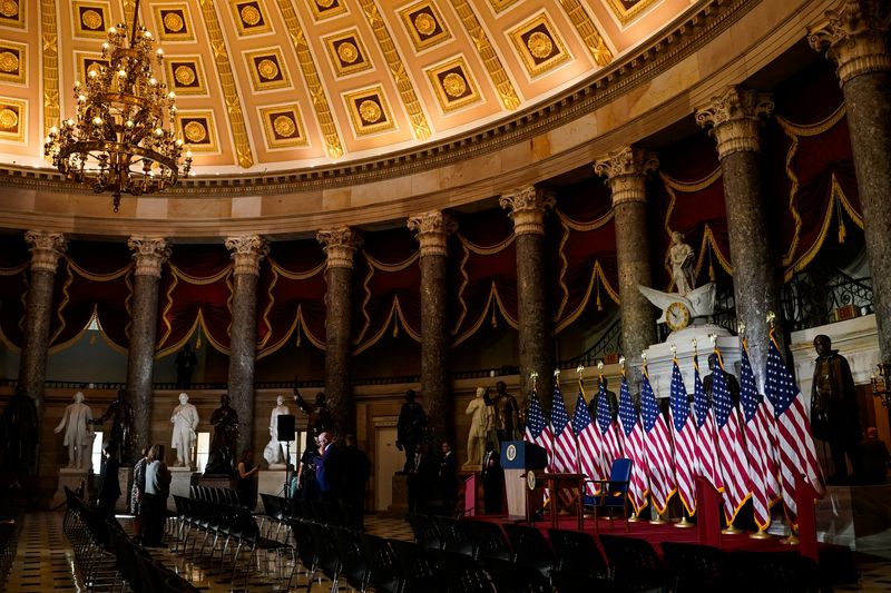 U.S. flags are illuminated on an event stage erected in Statuary Hall after U.S. President Donald Trump cancels a scheduled signing of a bipartisan legislation aimed at speeding up ​the construction and availability of more affordable housing, at the U.S. Capitol in Washington, D.C., U.S., June 24, 2026. REUTERS/Elizabeth Frantz