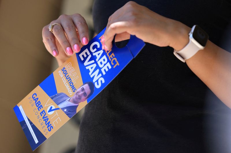 Gayle Sandoval holds a flyer supporting U.S. Rep. Gabe Evans (R-CO) in Brighton, Colorado, U.S., June 11, 2026. REUTERS/Kevin Mohatt