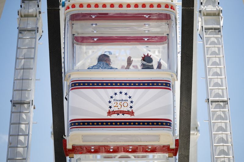 Visitors ride the Ferris wheel at the Great American State Fair on the National Mall in Washington, D.C., U.S., June 25, 2026. REUTERS/Tom Brenner