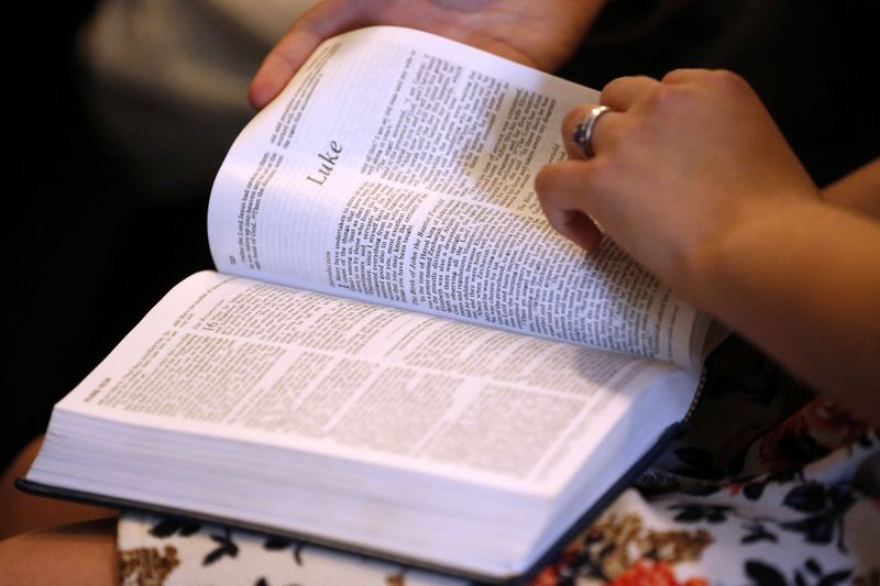 Members of the community read from the Bible during a prayer service at the Arcadia First Baptist Church in Santa Fe, Texas, U.S., May 20, 2018. REUTERS/Jonathan Bachman