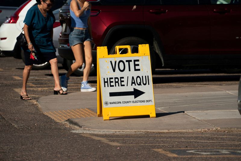 FILE PHOTO: A sign to guide voters to the polling station for the presidential election is seen in Scottsdale, Arizona, U.S., October 10, 2024.   REUTERS/Go Nakamura/File Photo