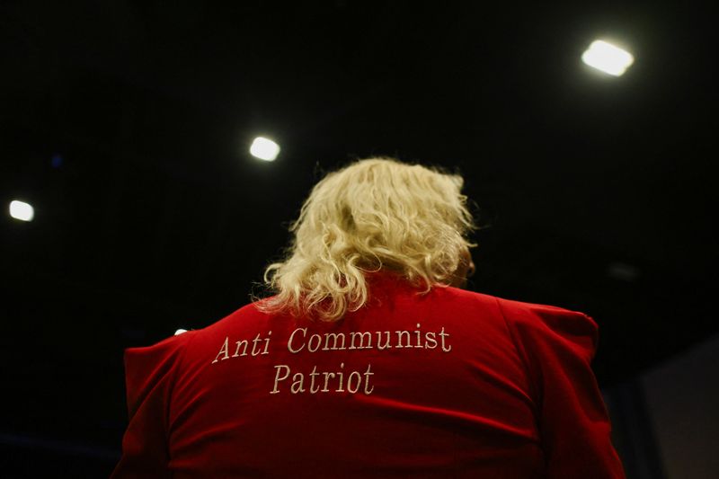 An attendee wears an outfit with "Anti Communist Patriot" written on it in Palm Beach County Convention Center, in West Palm Beach, Florida, U.S., November 5, 2024. REUTERS/Callaghan O'hare
