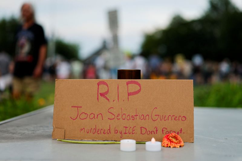 A handwritten cardboard memorial sign in the name of Joan Sebastian Guerrero is displayed during a candlelight memorial service at Mechanics Park, after a shooting involving U.S. Immigration and Customs Enforcement (ICE), in Biddeford, Maine, U.S., July 13, 2026.  REUTERS/CJ Gunther