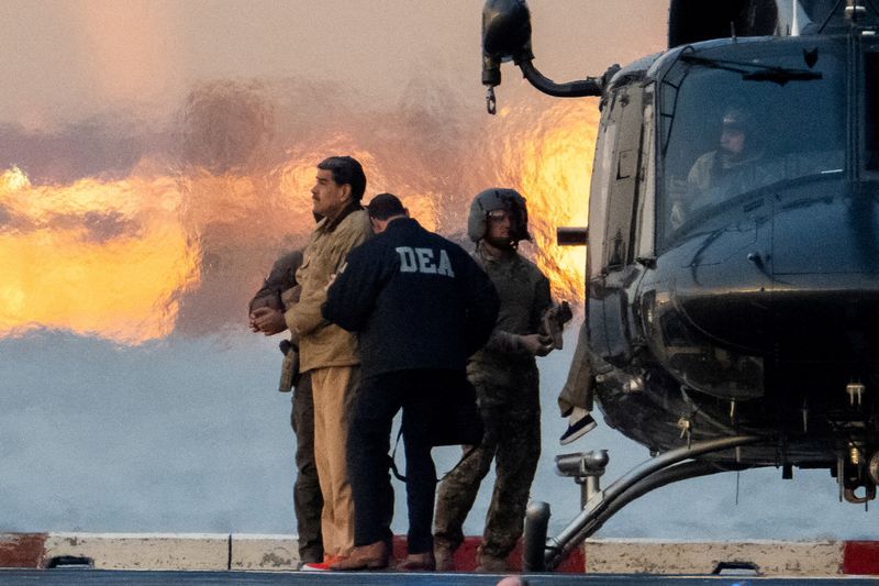 FILE PHOTO: Captured Venezuelan President Nicolas Maduro is escorted, as he heads towards the Daniel Patrick Moynihan United States Courthouse in Manhattan for an initial appearance to face U.S. federal charges including narco-terrorism, conspiracy, drug trafficking, money laundering and others at Downtown Manhattan Heliport, in New York City, U.S., January 5, 2026. REUTERS/Adam Gray/File Photo