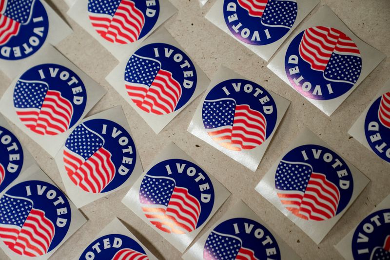 FILE PHOTO: Stickers are lined on a table for voters at the American Legion Post 53 polling location during the Wisconsin Supreme Court election in Eau Claire, Wisconsin, U.S., April 1, 2025.  REUTERS/Erica Dischino/File Photo