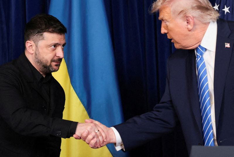FILE PHOTO: U.S. President Donald Trump and Ukrainian President Volodymyr Zelenskiy shake hands during a press conference after their lunch meeting at Trump’s Mar-a-Lago club, in Palm Beach, Florida, U.S., December 28, 2025. REUTERS/Jonathan Ernst/File Photo