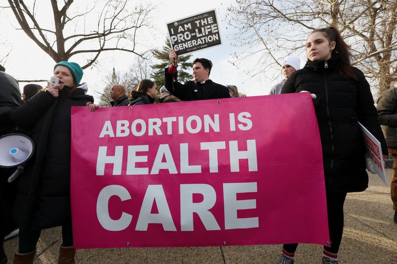 Demonstrators carry a banner during the annual "March for Life" in Washington, D.C., U.S., January 23, 2026.  REUTERS/Kylie Cooper