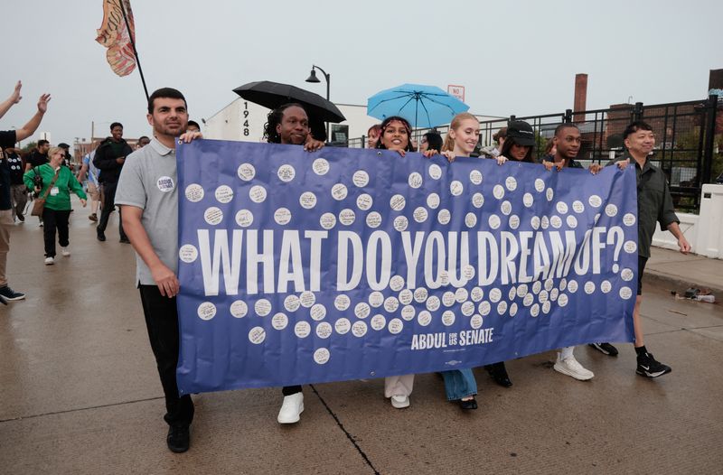 Supporters of U.S. Democratic Senate candidate Abdul El-Sayed  march with a banner during a campaign rally in Detroit, Michigan, U.S., August 2, 2026. REUTERS/Rebecca Cook