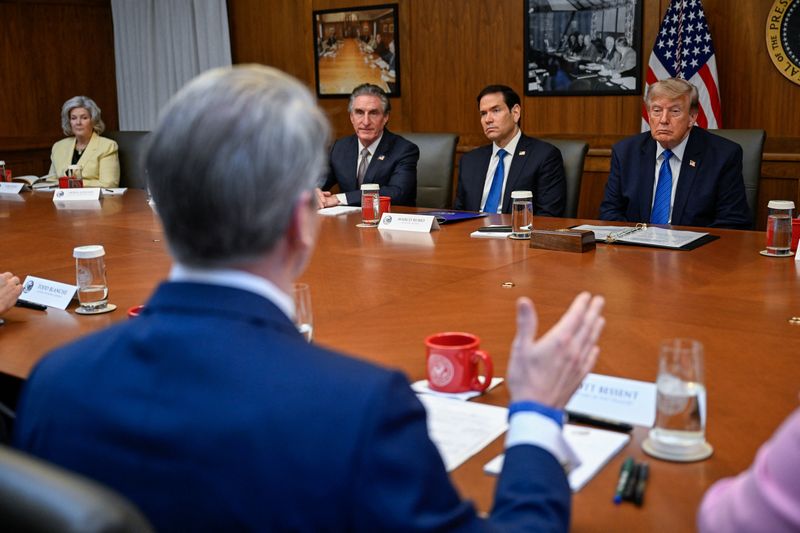 U.S. President Donald Trump listens as Secretary of the Treasury Scott Bessent speaks during a cabinet meeting at Camp David in Thurmont, Maryland, U.S., July 31, 2026. REUTERS/Daniel Heuer