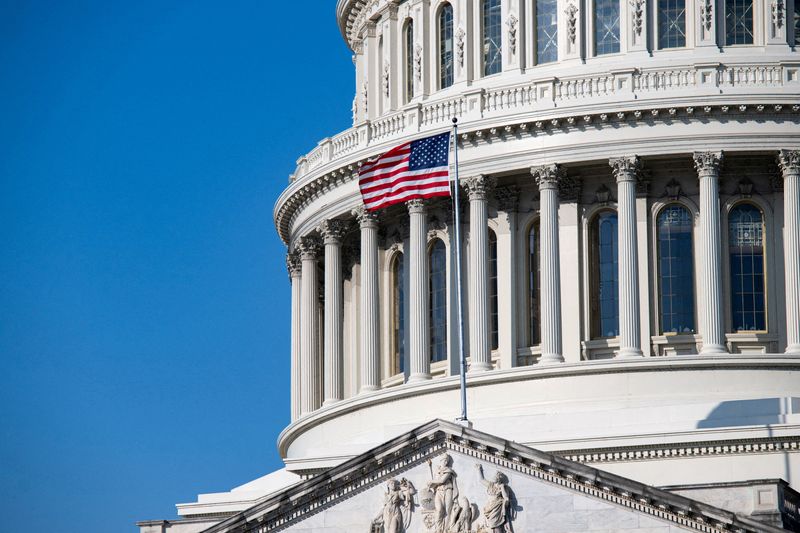 FILE PHOTO: The American flag waves from the U.S. Capitol in Washington, D.C., U.S., March 1, 2026. REUTERS/Annabelle Gordon/File Photo