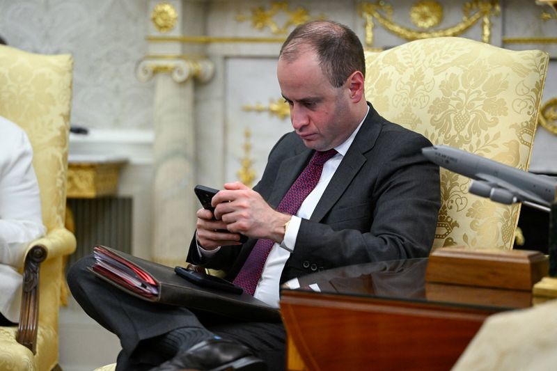 White House Staff Secretary Will Scharf looks at his phone during a speech of U.S. President Donald Trump in the Oval Office at the White House in Washington, D.C., U.S., June 11, 2026. REUTERS/Daniel Heuer