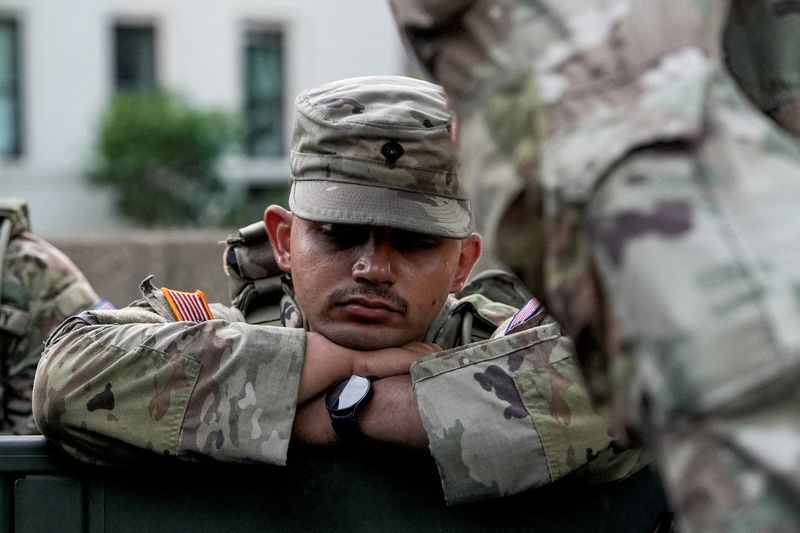 A member of the National Guard rests, after sunrise, as day breaks ahead of Fourth of July celebrations marking the 250th anniversary of U.S. Independence, in Washington, D.C., U.S., July 4, 2026. REUTERS/Cheney Orr