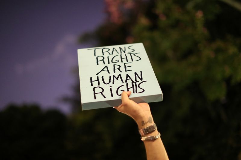FILE PHOTO: People hold pro-trans signs at a rally in Los Angeles, California, United States, October 22, 2018. REUTERS/Lucy Nicholson/ File Photo