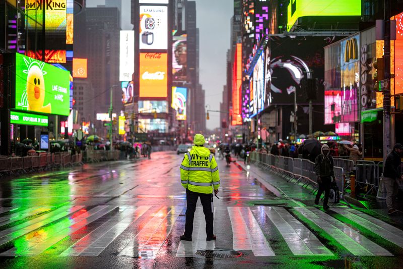 FILE PHOTO: A New York police officer directs traffic at Times Square in Manhattan in New York City, U.S., December 28, 2024. REUTERS/Marko Djurica/File Photo