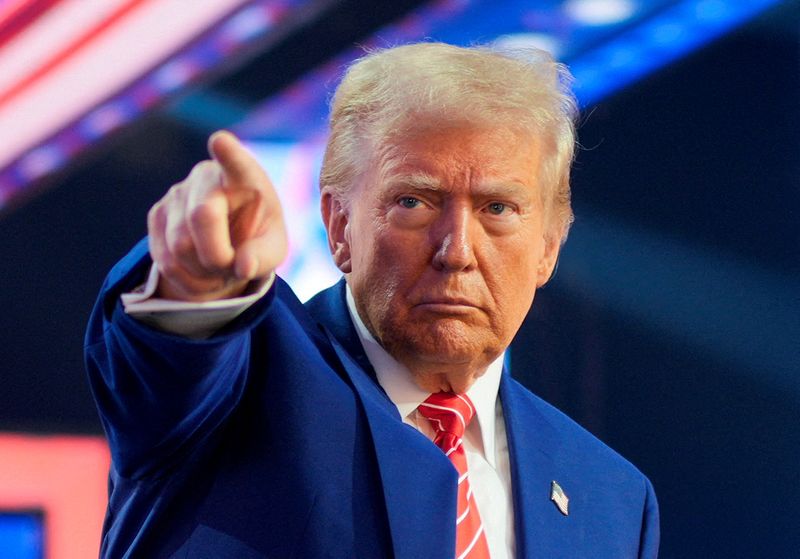 FILE PHOTO: U.S. President-elect Donald Trump gestures at Turning Point USA's AmericaFest in Phoenix, Arizona, U.S., December 22, 2024. REUTERS/Cheney Orr/File Photo
