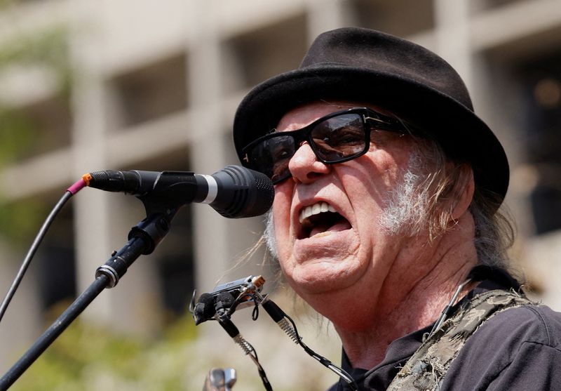 FILE PHOTO: Neil Young performs during a rally held by U.S. Senator Bernie Sanders (I-VT) and U.S. Representative Alexandria Ocasio-Cortez (D-NY) in Los Angeles, California, U.S., April 12, 2025. REUTERS/Carlin Stiehl/File Photo