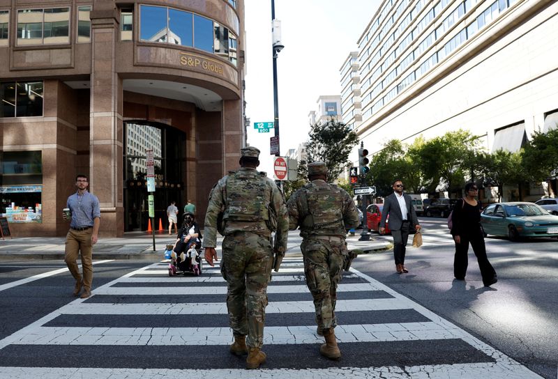 FILE PHOTO: Members of the National Guard patrol weeks after U.S. President Donald Trump ordered an increased presence of federal law enforcement to assist in crime prevention, in Washington, D.C. U.S., September 8, 2025. REUTERS/Daniel Becerril/File Photo