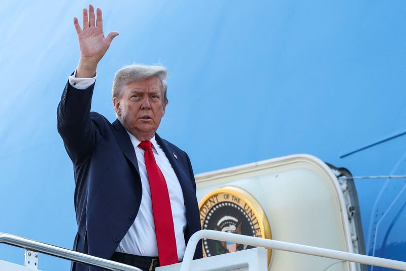 FILE PHOTO: U.S. President Donald Trump waves while boarding Air Force One from Joint Base Andrews in Maryland, U.S., August 15, 2025. REUTERS/Kevin Lamarque/File Photo