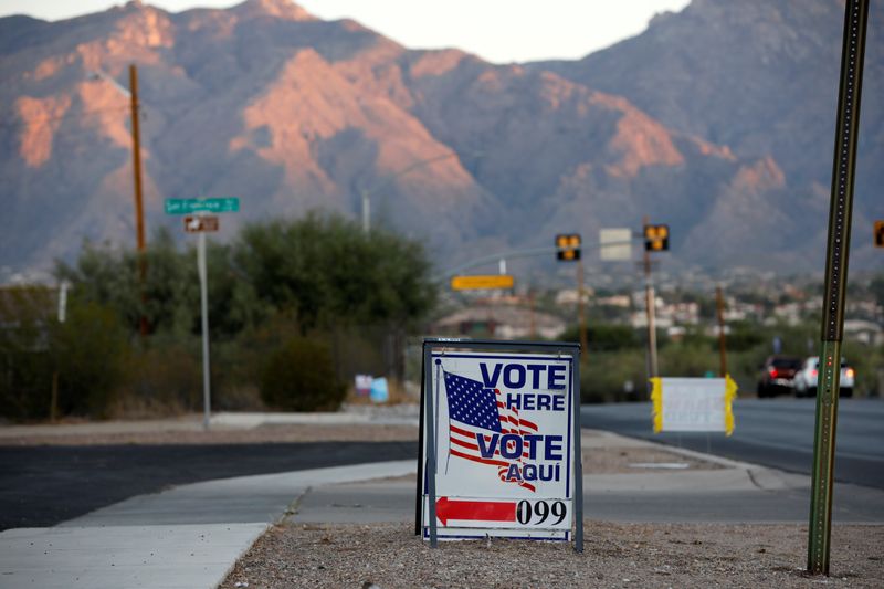 FILE PHOTO: Sign directs voters to a polling station on Election Day in Tucson, Arizona, U.S. November 3, 2020.  REUTERS/Cheney Orr/ File Photo