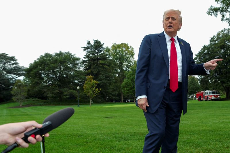 U.S. President Donald Trump speaks to members of the media as he arrives on the South Lawn of the White House in Washington, D.C., U.S., September 30, 2025. REUTERS/Ken Cedeno