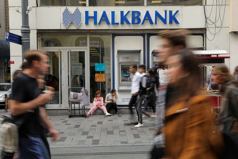 FILE PHOTO: People walk past by a branch of Halkbank in central Istanbul, Turkey, October 16, 2019. REUTERS/Huseyin Aldemir/File Photo