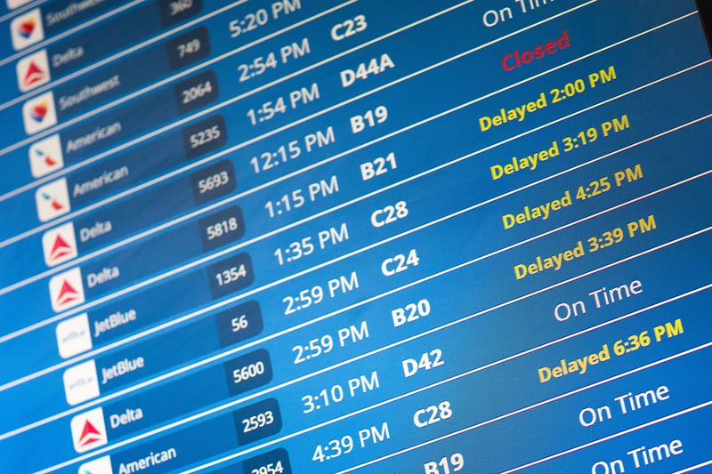 Information on delayed flights is displayed at Reagan Washington National Airport as the U.S. government shutdown continues in Arlington, Virginia, U.S., October 8, 2025. REUTERS/Nathan Howard