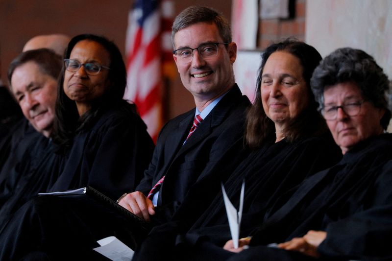 FILE PHOTO: U.S. District Judge Brian Murphy, who blocked the Trump administration for weeks from finalizing the deportation of eight men to South Sudan, sits with fellow judges during his Investiture Ceremony at the federal courthouse in Boston, Massachusetts, U.S., September 17, 2025.   The other judges are: U.S. District Court Judge Richard Stearns, U.S. District Court Chief Judge Denise Casper, U.S. District Court Judge Indira Talwani and U.S. District Court Judge Allison D. Burroughs.  REUTERS/Brian Snyder/File Photo