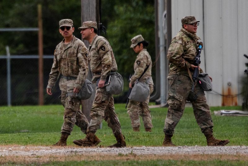 Texas National Guard troops walk through the Joliet Army Reserve Training Center, after U.S. President Donald Trump ordered increased federal law enforcement presence to assist in crime prevention, in Elwood, Illinois, U.S., October 7, 2025.  REUTERS/Jim Vondruska