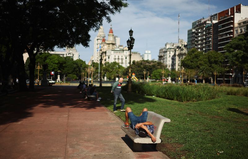 FILE PHOTO: A man rests on a bench in a public park in front of the National Congress, in Buenos Aires, Argentina February 12, 2025. REUTERS/Agustin Marcarian/File photo