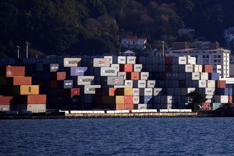 FILE PHOTO: Containers sit stacked at a port terminal with residential houses behind in Wellington, New Zealand, July 2, 2017. Picture taken July 2, 2017.   REUTERS/David Gray/File photo