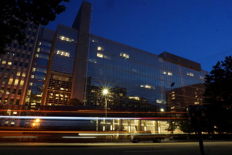 FILE PHOTO: Vehicles pass in front of the World Bank building, which houses the International Centre for Settlement of Investment Disputes, in Washington, D.C. on May 20, 2022. Picture taken with a long exposure. Picture taken May 20, 2022.  REUTERS/Raphael Satter/File Photo