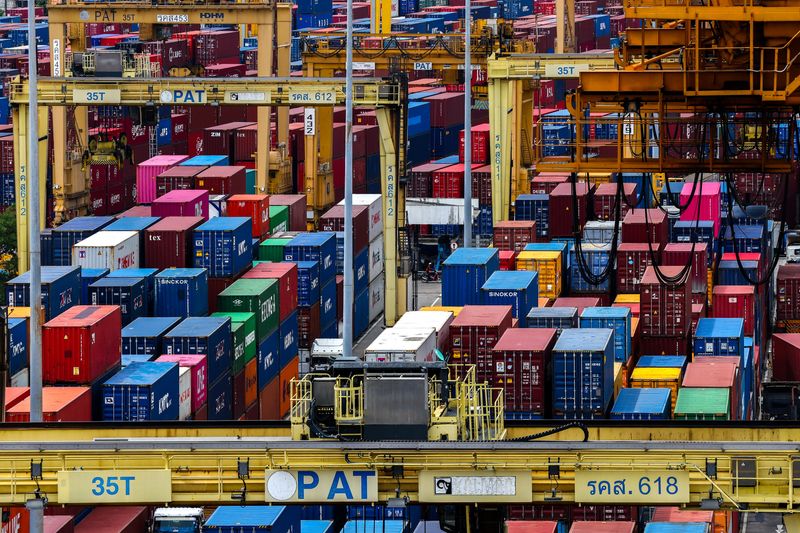A man rides a motorcycle past containers at a port under the Port Authority of Thailand, following the announcement that U.S. President Donald Trump would impose tariffs of 36% on goods from Thailand starting on August 1, in Bangkok, Thailand, July 8, 2025. REUTERS/Athit Perawongmetha