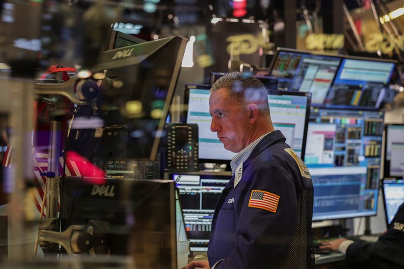 FILE PHOTO: A trader works on the floor at the New York Stock Exchange (NYSE) in New York City, U.S., July 8, 2025. REUTERS/Jeenah Moon/File Photo