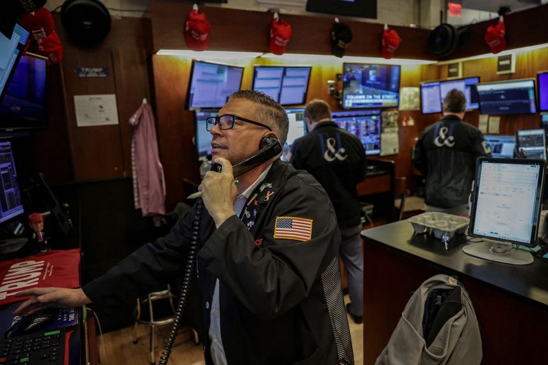 FILE PHOTO: A trader works on the floor at the New York Stock Exchange (NYSE) in New York City, U.S., July 14, 2025. REUTERS/Jeenah Moon/File Photo