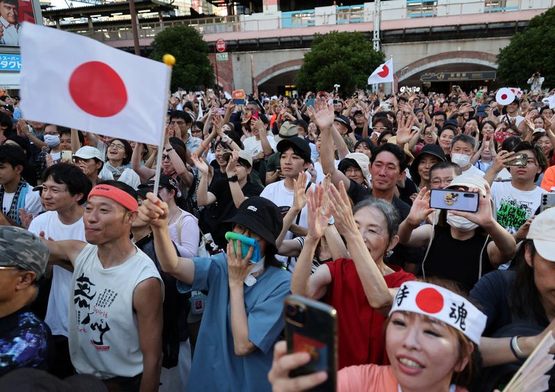 Supporters of Japan's Sanseito party leader react during the party’s rally in Tokyo, Japan, July 21, 2025, a day after the upper house election. REUTERS/Kim Kyung-Hoon/File Photo