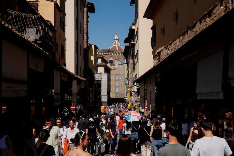 FILE PHOTO: People walk on the Ponte Vecchio (Old Bridge) in Florence, Italy April 13, 2024. REUTERS/Alessandro Garofalo/ File Photo