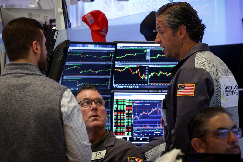 FILE PHOTO: Traders work on the floor at the New York Stock Exchange (NYSE) in New York City, U.S., July 24, 2025.  REUTERS/Brendan McDermid/File photo