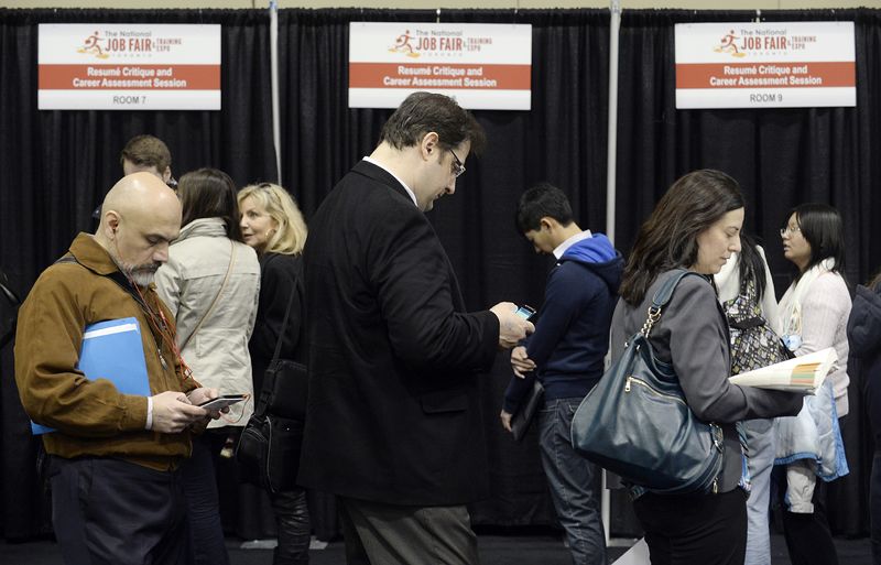 FILE PHOTO: People wait in line for resume critique and career assessment sessions at the 2014 Spring National Job Fair and Training Expo in Toronto, April 3, 2014. REUTERS/Aaron Harris/File Photo