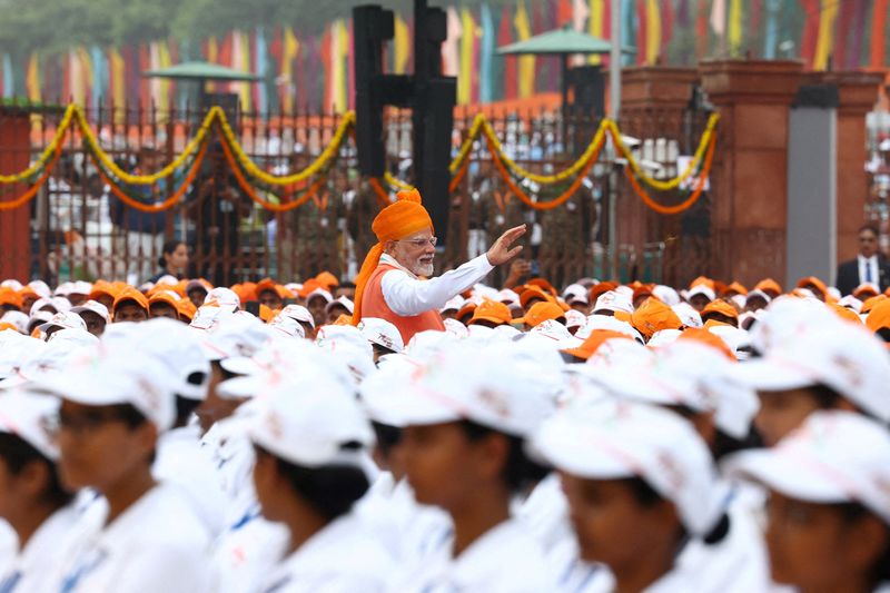 India's Prime Minister Narendra Modi waves at children after addressing the nation during Independence Day celebrations at the historic Red Fort in Delhi, India, August 15, 2025. REUTERS/Altaf Hussain