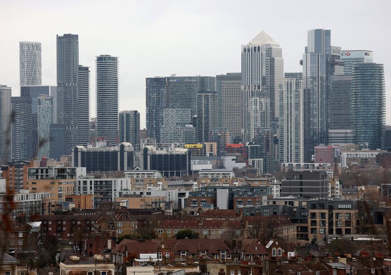 FILE PHOTO: A view of the Canary Wharf financial district and residential houses in London, Britain, January 23, 2025. REUTERS/Hannah McKay/ File Photo