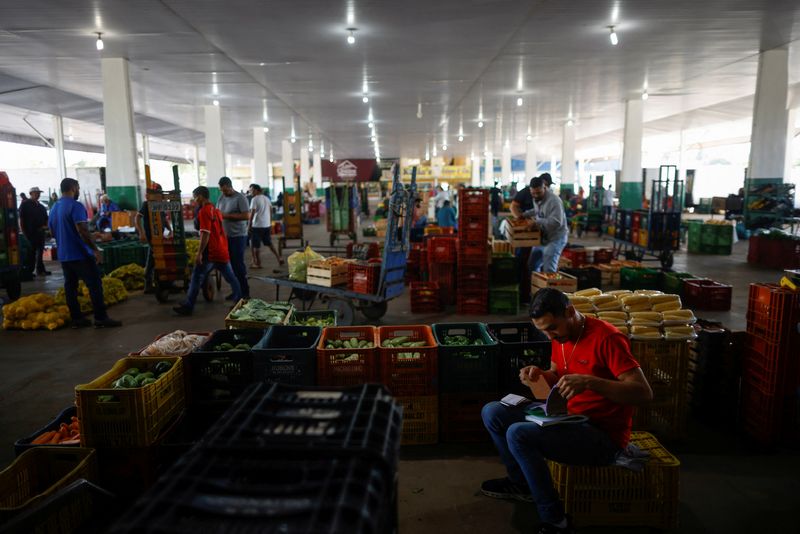 FILE PHOTO: People are seen buying from a supply centre (CEASA) in Brasilia, Brazil May 9, 2023. REUTERS/Adriano Machado/File Photo